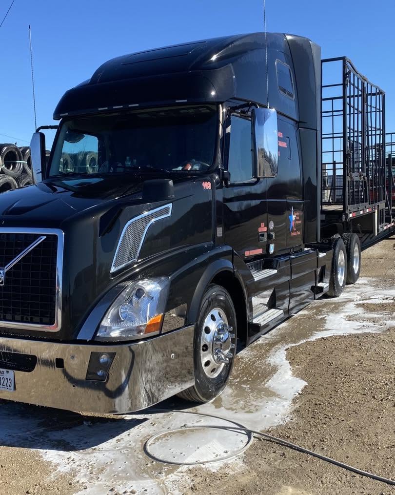 The same black Volvo semi truck rinsed, clean and shining